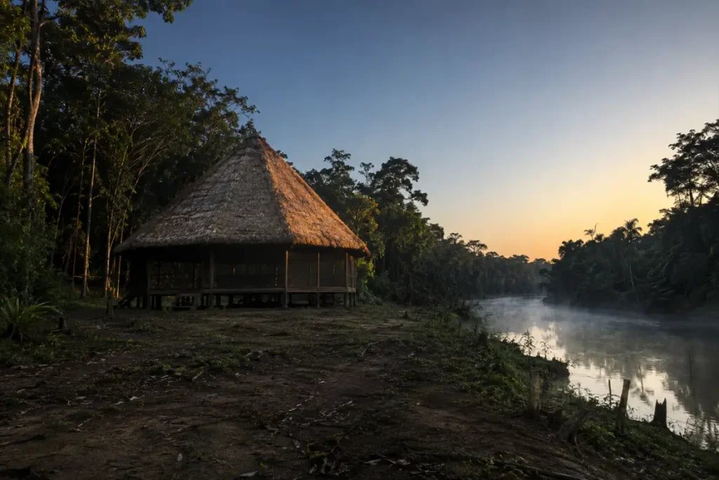 Octagonal thatched maloca at dawn beside the Río Momón near Iquitos, Peru