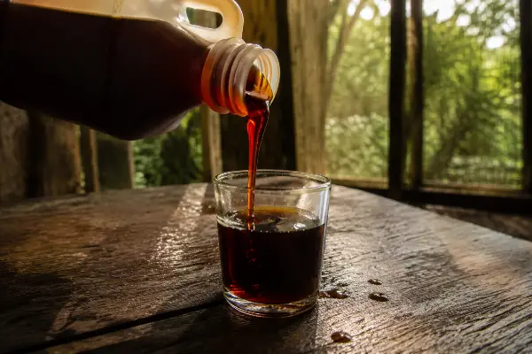 Ayahuasca brew poured into a cup, a liquid whose strength cannot be weighed