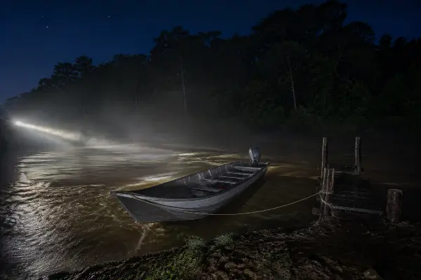 Fast launch tied at the dock at night, the medical evacuation boat for an Amazon retreat