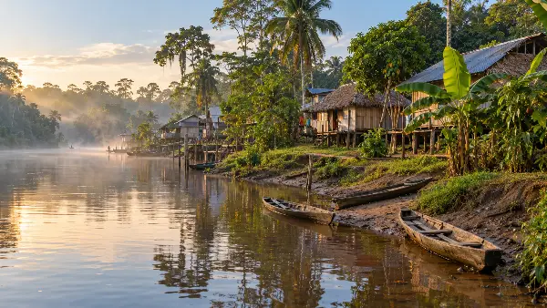 Stilt houses and canoes in a river community near Iquitos, Peru, where ayahuasca retreats operate