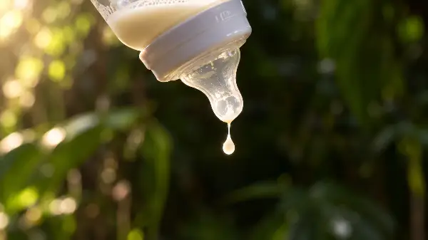 A drop of breast milk falling from a bottle, the drop no study has tested for ayahuasca while breastfeeding